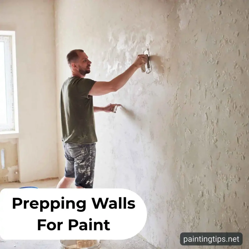 A person applying joint compound to fill cracks and holes in a wall before painting.